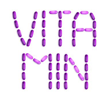 The word Vitamin is laid out with pills. The word Vitamin is laid out with gel pills on a white background with copy space for text.