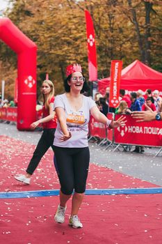 POLTAVA, UKRAINE - 1 SEPTEMBER 2019: A mature woman reaches finish line during Nova Poshta Poltava Half Marathon.