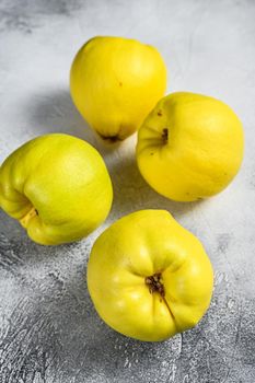 Fresh quince fruits on white table. White background. Top view.