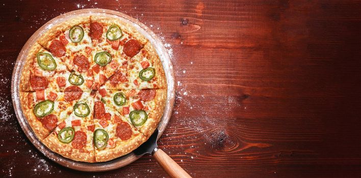 fresh american pizza on wooden table with space for text