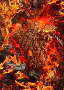 grilled marbled beef steak with coals and smoke