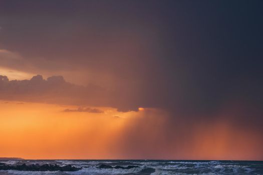 Sunrise sunset with beautifukls clouds and rays of light at the sea.