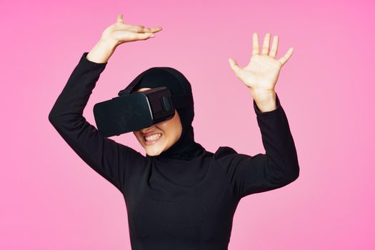 muslim woman wearing virtual reality glasses entertainment technology device. High quality photo