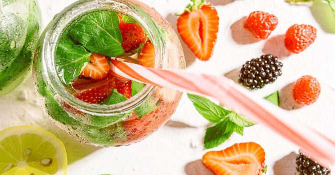 detox smoothies of fresh fruits and vegetables in glass jars with tubes. studio light, light background, space for text