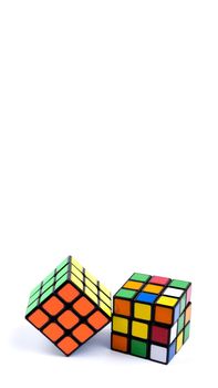 Game multi-colored cube on a white background. Vertical orientation Game concept with copy space for text.