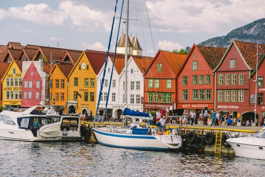 Bergen, Norway. View of historical buildings in Bryggen. Hanseatic wharf in Bergen, Norway July 28, 2019. UNESCO. Famous Bryggen street with wooden colored houses in Bergen Akerbrygge distric.