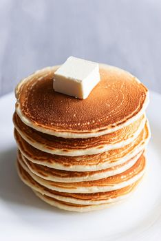 fresh classic pancake stacked in stack on gray background with place for text