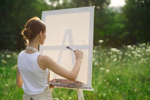 woman artist outdoors paint palette painting landscape. High quality photo