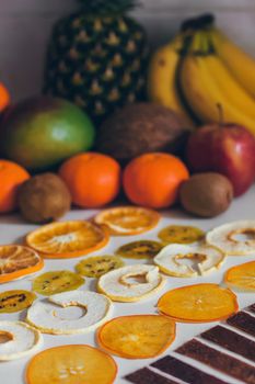 Dried homemade healthy fresh dehydrated slices of fruits. Fruit chips, natural raw vegan organic snack. Healthy food concept.