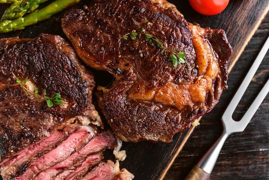 Dinner for two juicy delicious steaks, asparagus with parmesan and vegetables.