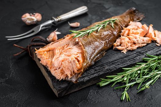 Salmon Hot smoked, trout fish meat. Black background. Top view.