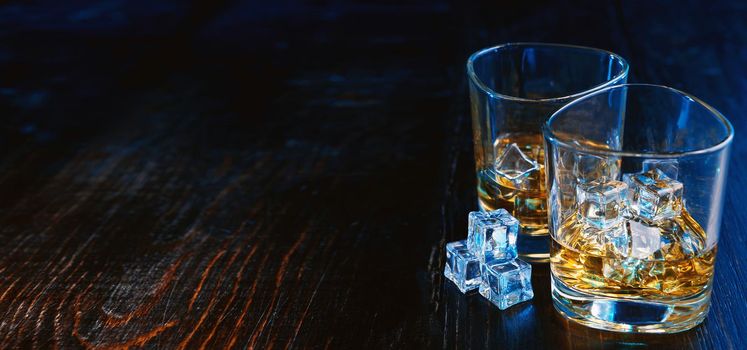 whiskey with ice in modern glasses