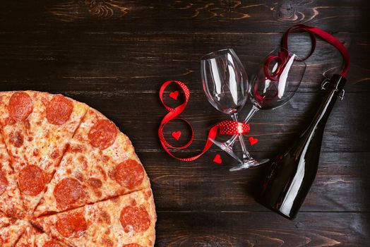 dinner for two in honor of Valentine's Day with pizza and wine.