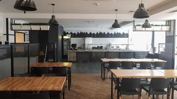 Ukraine, Kiev - June 5, 2020. The interior of the cafe. Stylishly decorated restaurant with no visitors. Modern public dining room