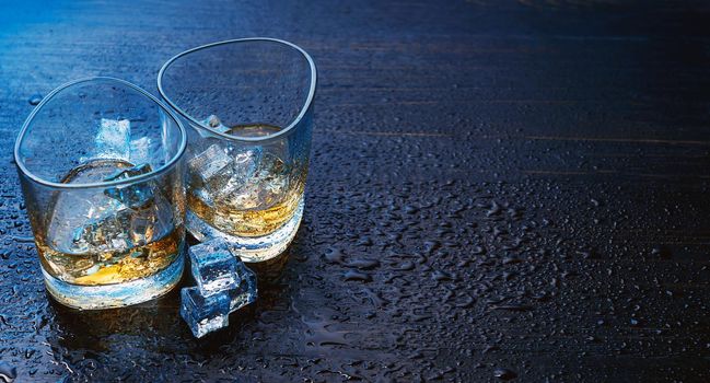 whiskey with ice in modern glasses