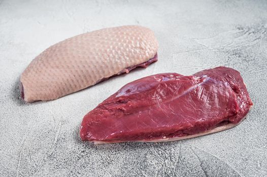 Raw uncooked Duck breast fillet steaks on butcher table. White background. Top View.