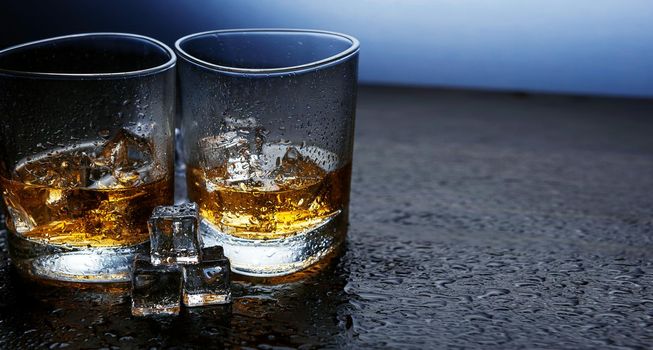 whiskey with ice in modern glasses