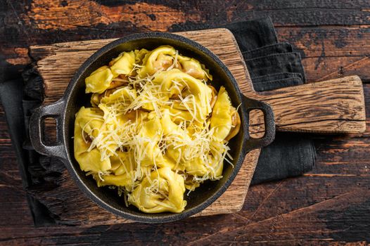 Ravioli Pasta with Mozzarella, parmesan cheese and Tomato. Wooden background. Top view.