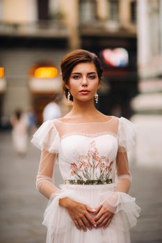 girl-bride wedding dress with a beautiful floral pattern in Florence, stylish bride in a wedding dress stands in the Old city of Italy. Model girl in Florence.