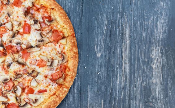 pizza close-up on a wooden surface