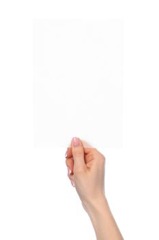 Female hand holding blank white sheet of paper isolated on white background