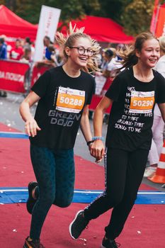 POLTAVA, UKRAINE - 1 SEPTEMBER 2019: Two teenage girls reachefinish line during Nova Poshta Poltava Half Marathon.