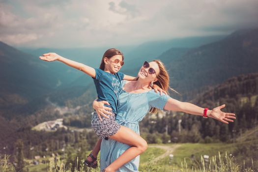 Mother hugging daughter. Holiday trip concept.