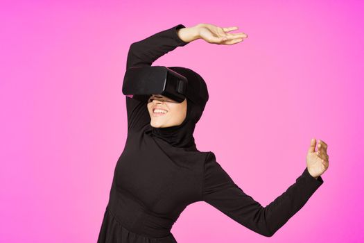 woman in black hijab glasses virtual reality technology movie watching. High quality photo