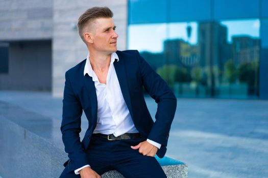 Business. Businessman Sitting City Street Office Building Handsome Caucasian Serious Male Business Person Portrait Corporative Building Background Successful Young Adult Manager Dressed Business suit no tie