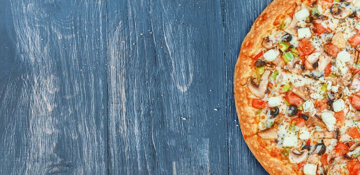 pizza close-up on a wooden surface