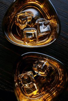 whiskey with ice in modern glasses