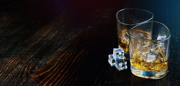 whiskey with ice in modern glasses