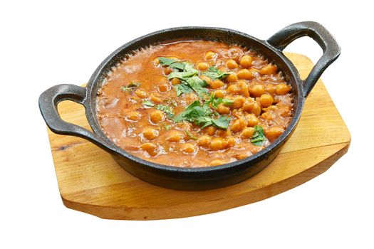 Overhead  shot of chana masala in little pan. Isolated on white with clipping path