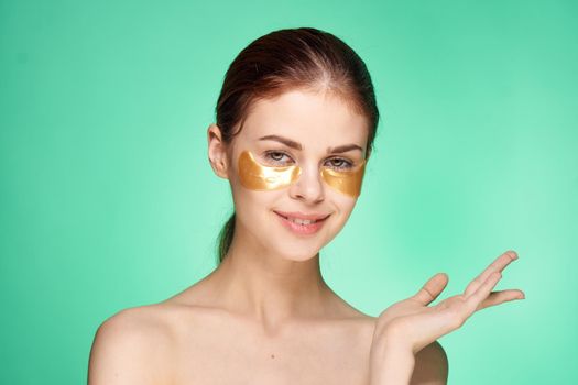 pretty woman naked shoulders gold face patches cosmetics. High quality photo