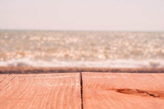 Abstract nature summer or spring ocean sea background. Small waves on golden warm water surface in motion blur with bokeh lights from sunrise. Holiday, vacation and recreational background concept.