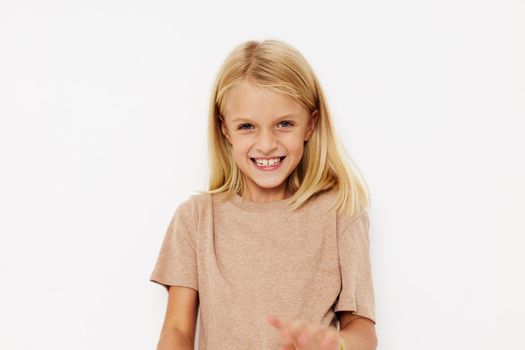 Portrait of a smiling little cutie blank space for logo design on a light background. High quality photo