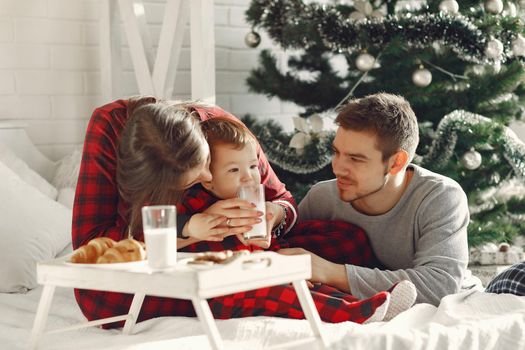 People at home. Family in a pajamas. Milk and croissants on a tray.