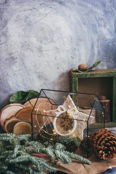 Christmas composition with nuts, garland, star, wooden decor rustic wooden box and fir tree branch. Rustic style