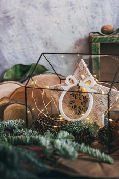 Christmas composition with nuts, garland, star, wooden decor rustic wooden box and fir tree branch. Rustic style