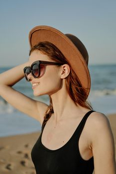 pretty woman in hat and sunglasses on the beach walk sun. High quality photo