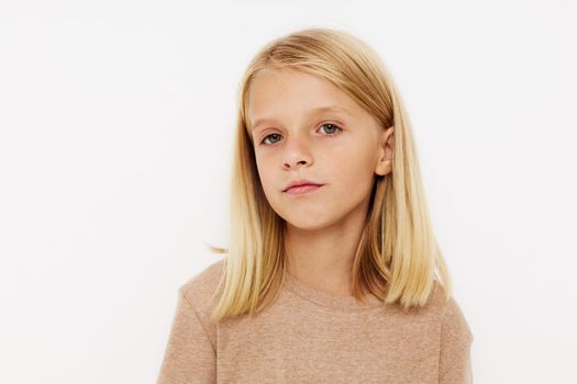 Portrait of a smiling little cutie gestures with his hands posing studio. High quality photo