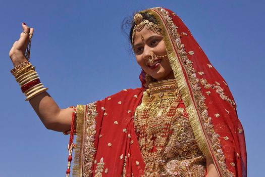 Jaisalmer, Rajasthan, India - February 19, 2008: Indian lady dressed in ornate red sari and adorned with traditional Indian jewellery at the annual Desert Festival in Jaisalmer.