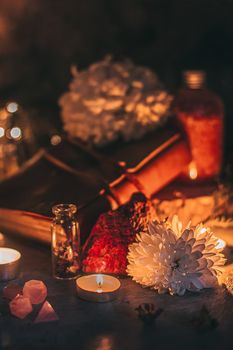 Mysterious halloween scene, witchcraft practicing, ritual candles. Fairytale, fairies theme, gemstones, flowers love magic white magic