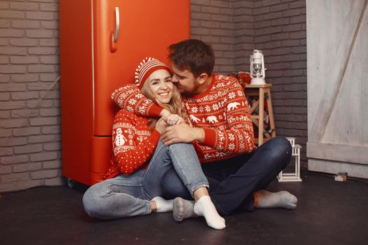 People in a Christman decorations. Man and woman in a red sweater. Family at home.