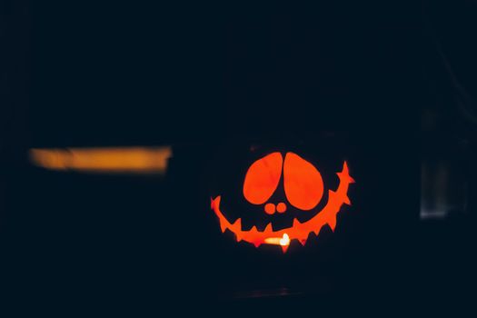 Scary Halloween pumpkins isolated on a black background. Scary glowing faces trick or treat.