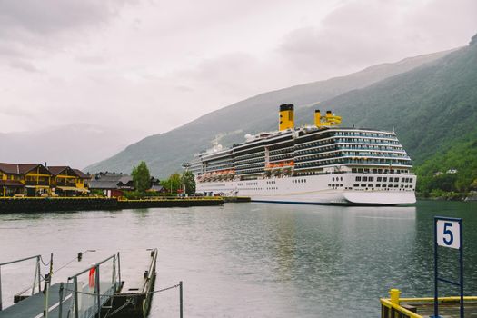 Cruise Liner In The Waters Of Aurlandsfjord, Norway. View of a passenger cruise ship in the port of Flam. cruise liner docked in fjord of Flam.
