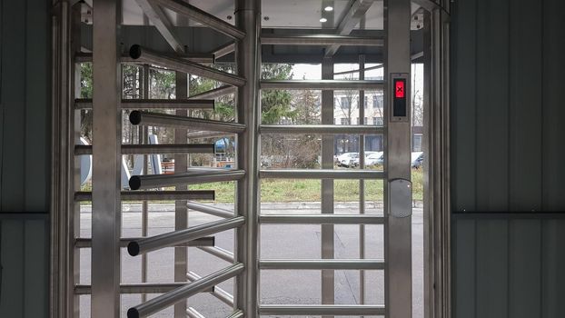 Ukraine, Kiev - May 12, 2020: Full-size turnstile, guarded entrance. Revolving door. Card key, rotating entrance with card pass system