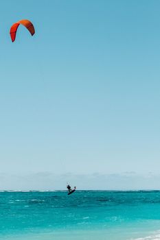A man paragliding on Le Morne beach, Mauritius, Indian ocean on the island of Mauritius.