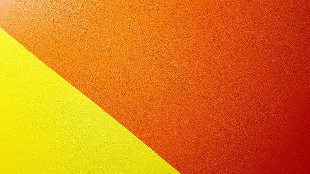 Red and yellow painted wall texture abstract grunge background with copy space. Abstract geometric pattern on the wall. The wall is divided into borders of different colors.