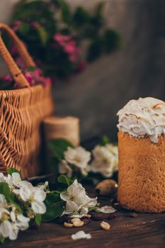 Traditional Russian Orthodox Easter bread kulich with apple blossom and colored eggs